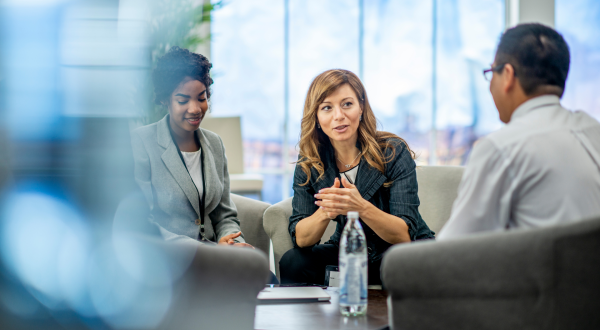 business people sat casually discussing around a round table