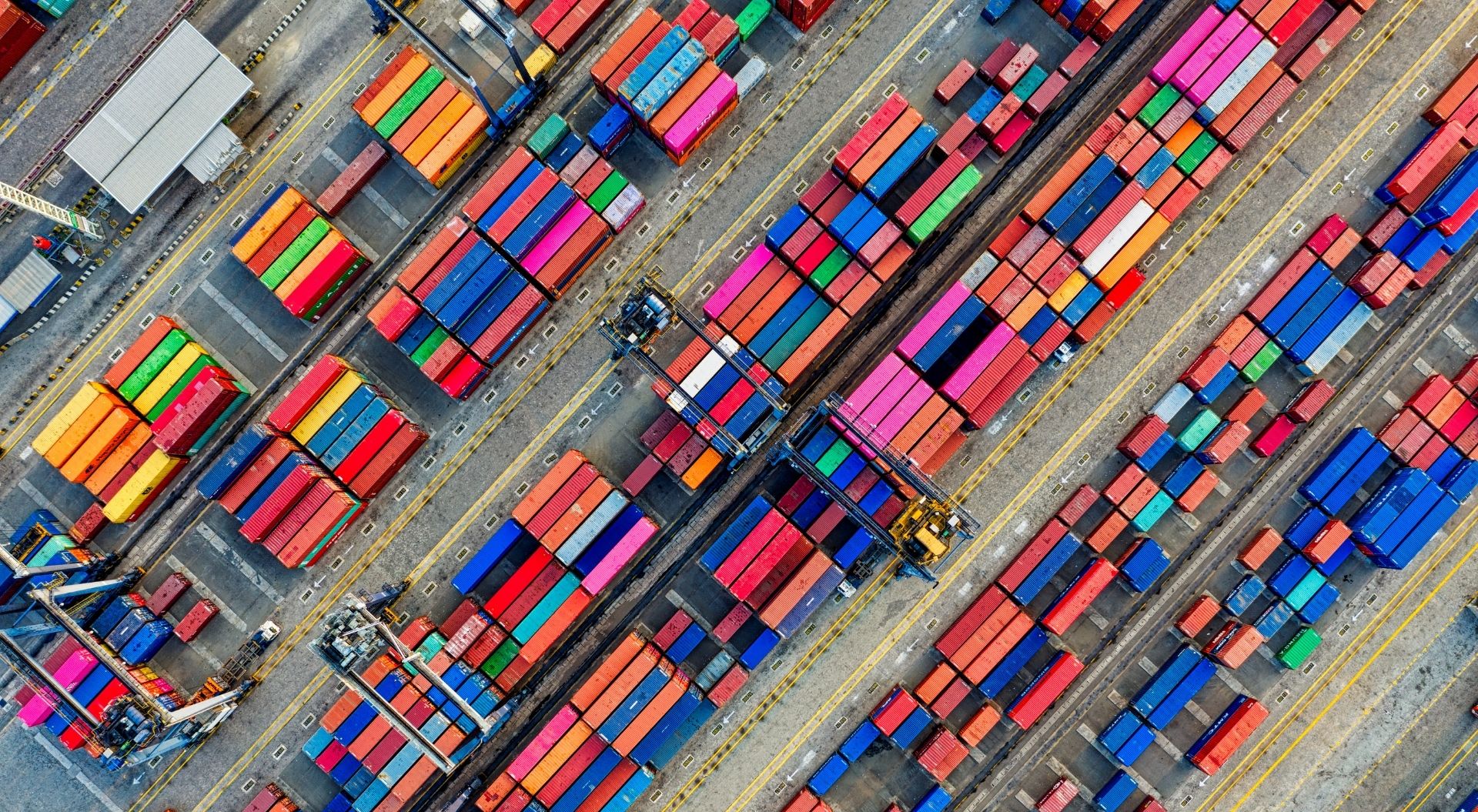 `An aerial view of a global shipping and logistics hub, representing the scale and complexity of extended enterprise training across distributed partner and customer networks.