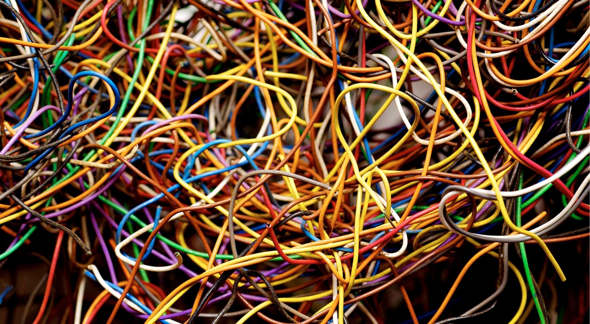 A tangle of multicolored cables, representing the complexity and operational burden of managing fragmented learning technology systems.